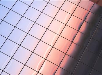 A close up of the reflection of a sky in tiles.