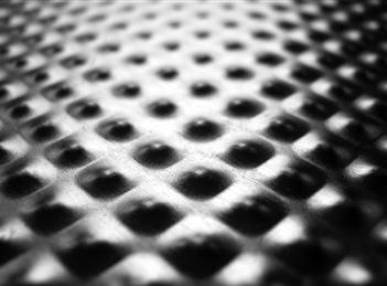 A close up of the metal surface with dots.